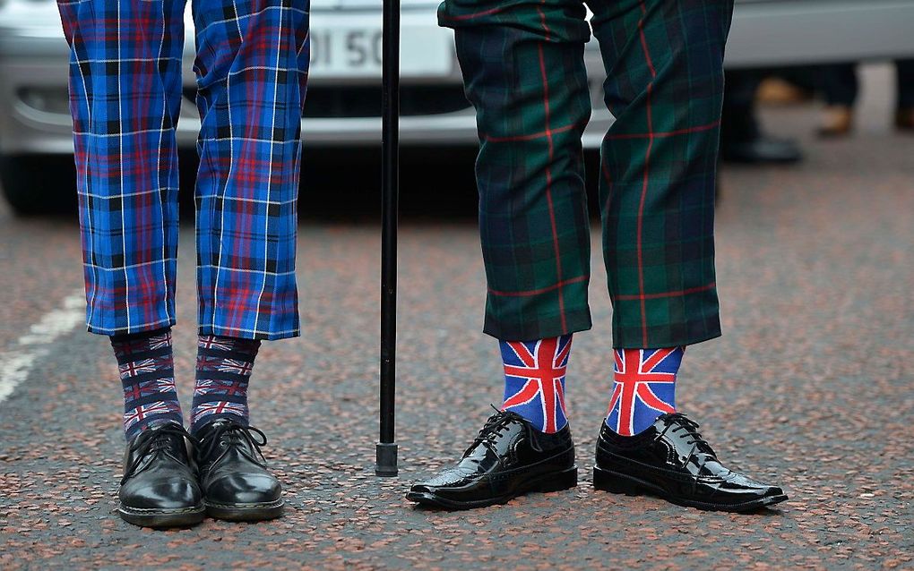 Oranjemars in Belfast. Op 12 juli vinden in heel Noord-Ierland Oranjemarsen plaats, waarmee unionisten de overwinning van de protestant Willem III op de katholieke koning Jacobus II van Engeland herdenken. beeld EPA, MARK MARLOW