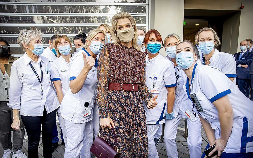 Verpleegkundigen poseren voor een foto met koningin Máxima. beeld ANP, Patrick van Katwijk