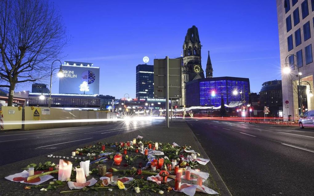 BERLIJN. Op de plaats van de aanslag in Berlijn liggen bloemen en worden kaarsjes aangestoken. De dader was vanmorgen nog steeds voortvluchtig. De Duitse politie zoekt vooral in de grensstreek tussen Duitsland en Nederland. beeld EPA, Rainer Jensen