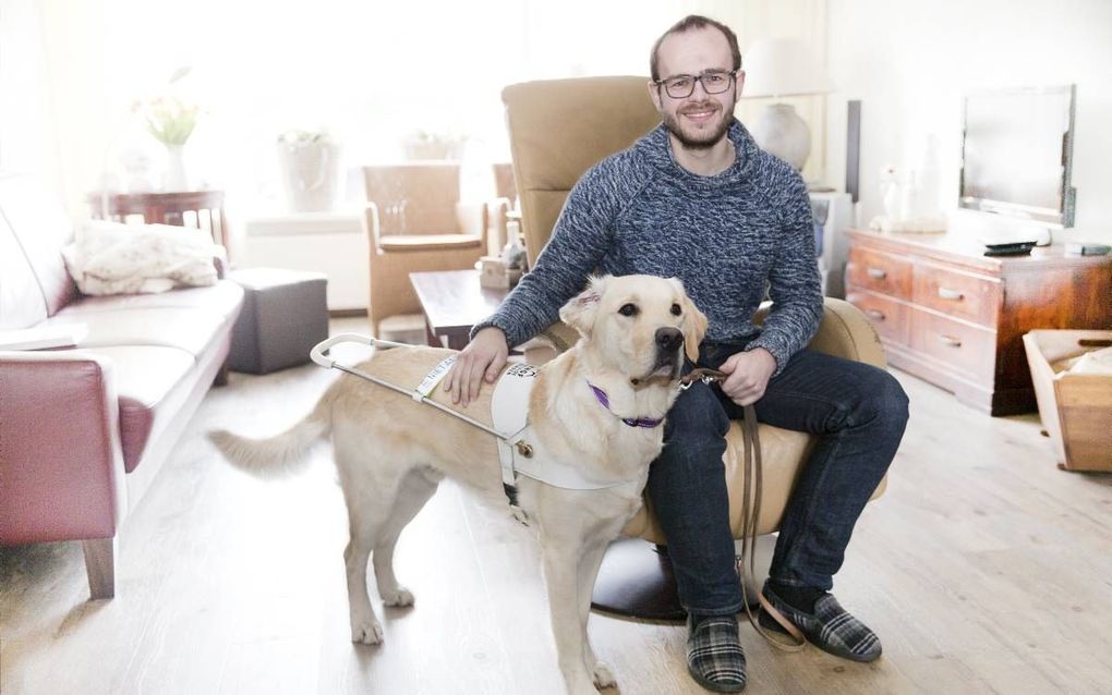 Jorrit Overweg (25) uit Wezep heeft het syndroom van Usher, wat kan leiden tot totale doof- en blindheid. Hond Nigel is hem tot grote steun. beeld RD, Henk Visscher