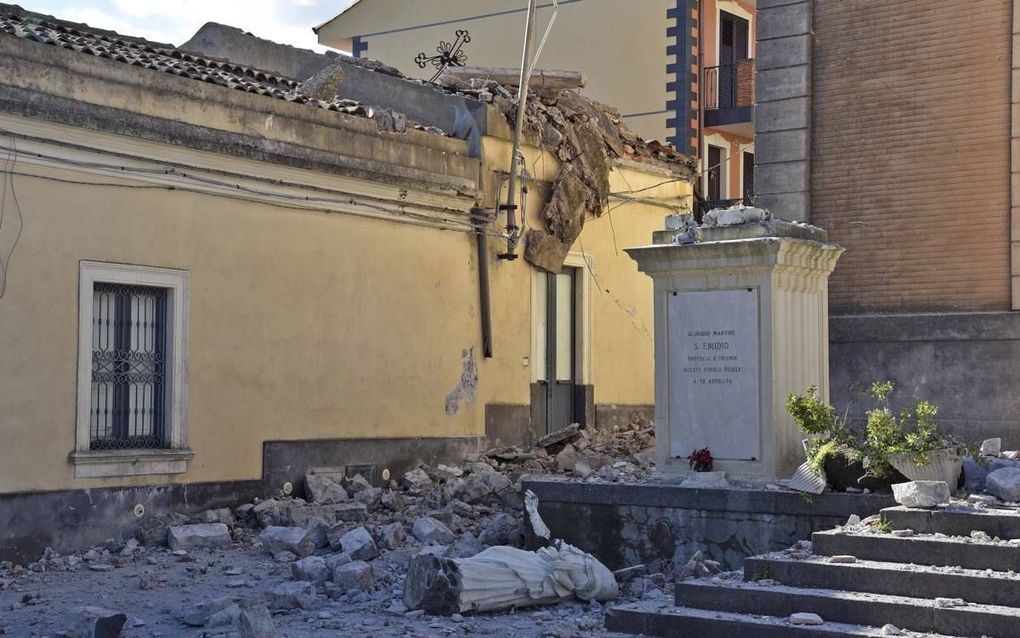 Het beeld van de heilige Emygidius is woensdag van de façade van een kerk in Catania gevallen. beeld AFP, Giovanni Isolino