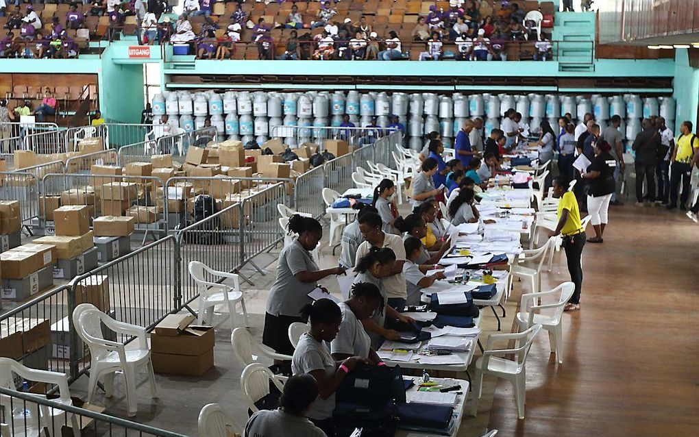 Telling van stemmen in de Anthony Nesty Sporthal in Paramaribo, woensdag. De verkiezingen in Suriname verliepen behoorlijk chaotisch, de officiele uitslag is nog niet bekend. beeld ANP, Ranu Abhelakh