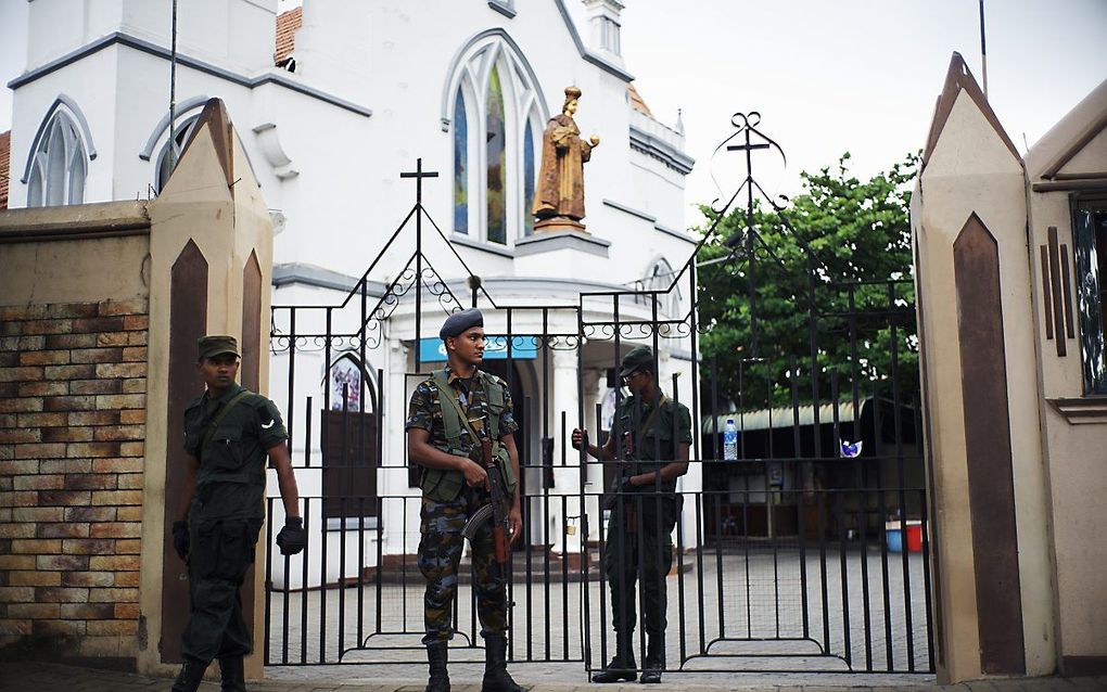 Agenten bewaken een kerk in Colombo, Sri Lanka, na de aanslagen in april. beeld AFP, Jewel Samad