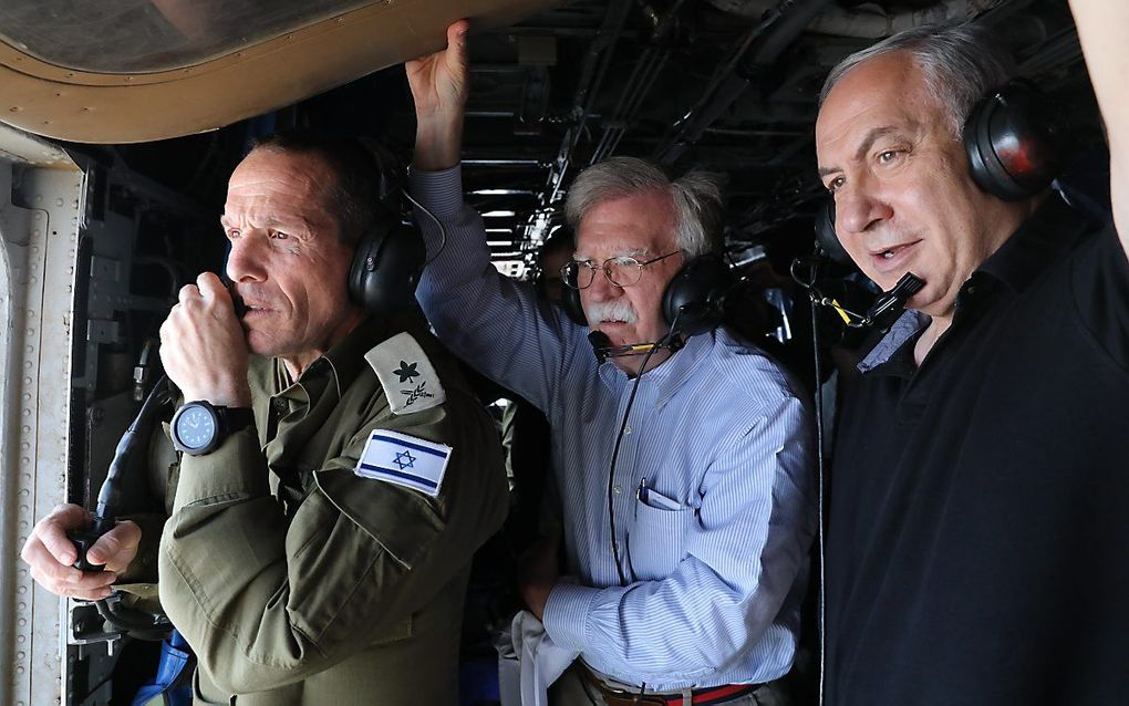 John Bolton (m.) met de Israëlische premier Netanyahu (r.) en legerchef Nadav Padan, tijdens een helikoptervlucht over de Joraan, afgelopen weekeinde. beeld EPA