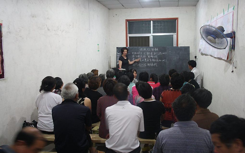 Een bijeenkomst in een kerkzaal in een lokaal Chinees boerendorp. beeld RD