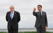 De Britse premier Johnson en de Franse president Emmanuel Macron. beeld AFP