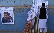 Abdul Ghani Baradar op een poster in Kabul. beeld AFP, Aamir Qureshi