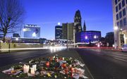 BERLIJN. Op de plaats van de aanslag in Berlijn liggen bloemen en worden kaarsjes aangestoken. De dader was vanmorgen nog steeds voortvluchtig. De Duitse politie zoekt vooral in de grensstreek tussen Duitsland en Nederland. beeld EPA, Rainer Jensen