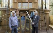 Jan (r.) en Peter van den Heuvel in hun montagehal in Dordrecht, waar momenteel het orgel voor de hersteld hervormde gemeente van Ouderkerk aan den IJssel wordt opgebouwd. beeld Sjaak Verboom