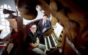 Ard van der Linden (achter) en Steven Knieriem geven samen orgelconcerten. Foto: achter de klavieren van het orgel in de Noorderkerk in Den Haag. beeld Martijn Beekman