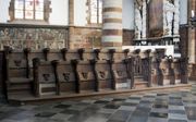 In de Onze-Lieve-Vrouwekerk in het Belgische Aarschot staat een middeleeuwse koorbank van de hand van Jan Borchman.  beeld Christel Theunissen