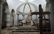 Christenen in Irak en Syrië hadden het zwaar, maar hun toekomst ziet er ook somber uit. Foto: een vernielde kerk in Irak. beeld AFP, Thomas Coex