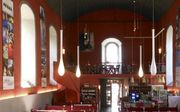 De kerkzaal van de Sint-Egidiuskerk in de Duitse stad Hannoversch Münden. De banken zijn veranderd in gedekte tafels en er is een bar geplaatst. Het kerkgebouw wordt sinds 2010 gebruikt door Café Aegidius. beeld Wikimedia