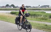 Simon Koster (26) uit Ridderkerk fietste al in tal van Europese landen. beeld RD, Anton Dommerholt