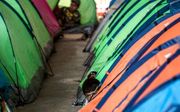 Mexicaanse migranten in een tentenkamp in de grensstad Tijuana. beeld AFP, Guillermo Arias