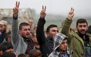 Koerden protesteren aan de Turks-Syrische grens in verband met de aangekondigde terugtrekking van de Amerikanen en de Turkse dreiging als gevolg daarvan. beeld AFP, Delil Souleiman