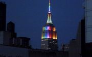 Het Empire State Building in New York in regenboogkleuren, tijdens de Gay Pride van 2014. De scherpe toon van de Nashvilleverklaring moet gelezen worden „als een statement in de richting van de homolobby”, zegt betrokkene Albert Mohler. „Dat was in Amerik