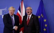 Johnson (l.) en Juncker. beeld EPA, Oliver Hoslet