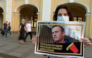 Navalni is vergiftigd, zegt een demonstratiebordje. beeld AFP, OLGA MALTSEVA