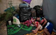 Dakloos geraakte vluchtelingen op Lesbos. In Nederland worden meer dan 15.000 slaapzakken ingezameld voor vluchtelingen die op het Griekse eiland op straat slapen, nadat kamp Moria in vlammen op ging. beeld AFP, Ouisa Gouliamaki