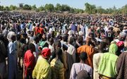 Begrafenis van arbeiders die werden gedood door Boko Haram. beeld AFP, Audu Marte