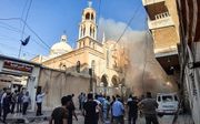 Een autobom ontplofte donderdag bij een kerk in de Syrische stad Kamishli. beeld AFP, Gihad Darwish