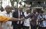 President Desi Bouterse woensdag bij zijn vertrek uit het parlementsgebouw, nadat hij de volksvertegenwoordigers had ingelicht over het blokkeren van het proces rond de Decembermoorden. beeld ANP, Pieter van Maele