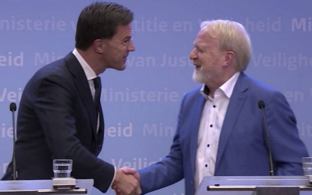 Geen handen meer schudden reduceert de verspreiding van het coronavirus met 6 procent, stelt het RIVM. Foto: premier Rutte schudt RIVM-baas de hand, kort nadat hij heeft gezegd dat het beter is om dit niet meer te doen. beeld NOS