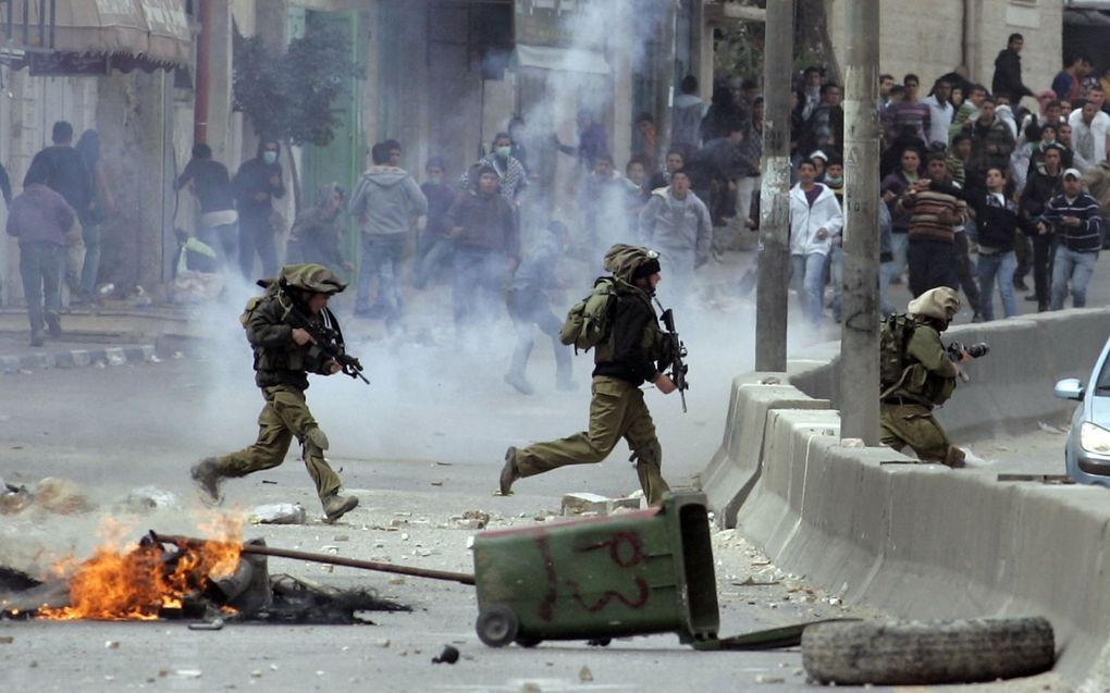 Palestijnse betogers botsen met Israëlische ordetroepen in de buurt van een checkpoint bij Ramallah.  beeld AFP, Abbas Momani