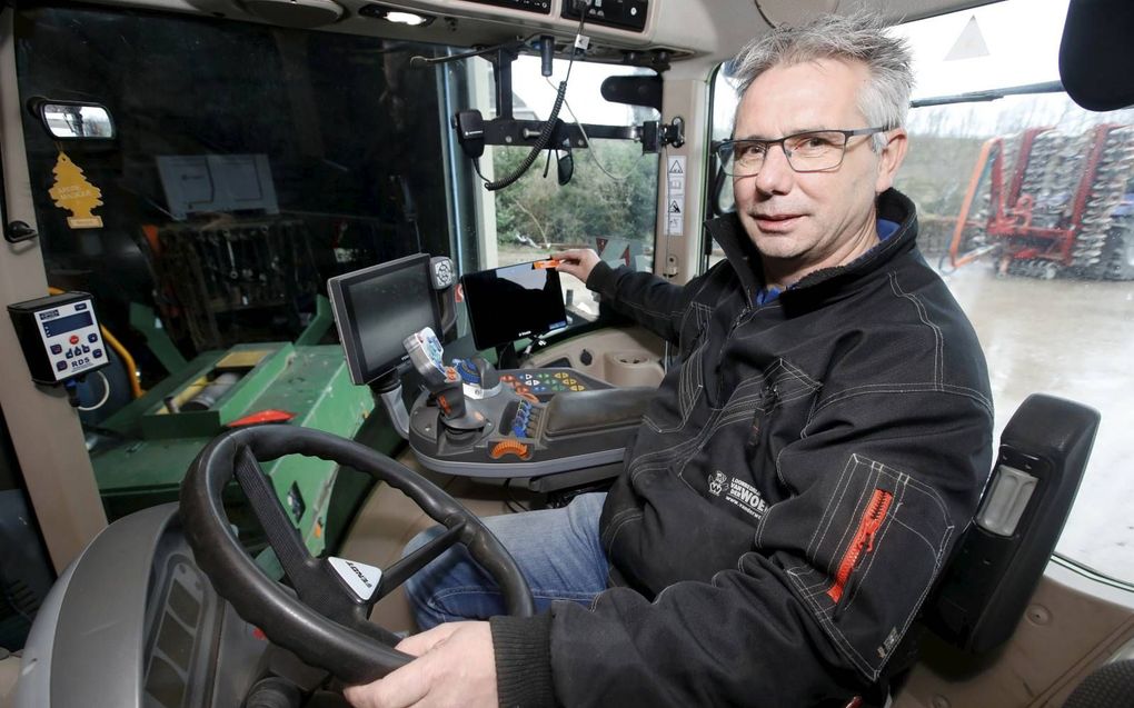 Gijs van der Woerd van het gelijknamige loonbedrijf in Zoelen, bij een van zijn voertuigen waarin de gps-systemen al zijn gelabeld. beeld VidiPhoto