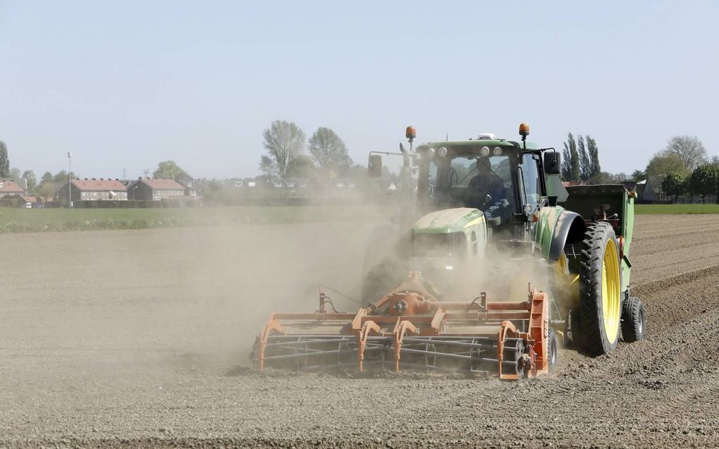 Een akkerbouwer poot aardappelen. De Europese Commissie wil dat boeren grond braak laten liggen.  beeld VidiPhoto