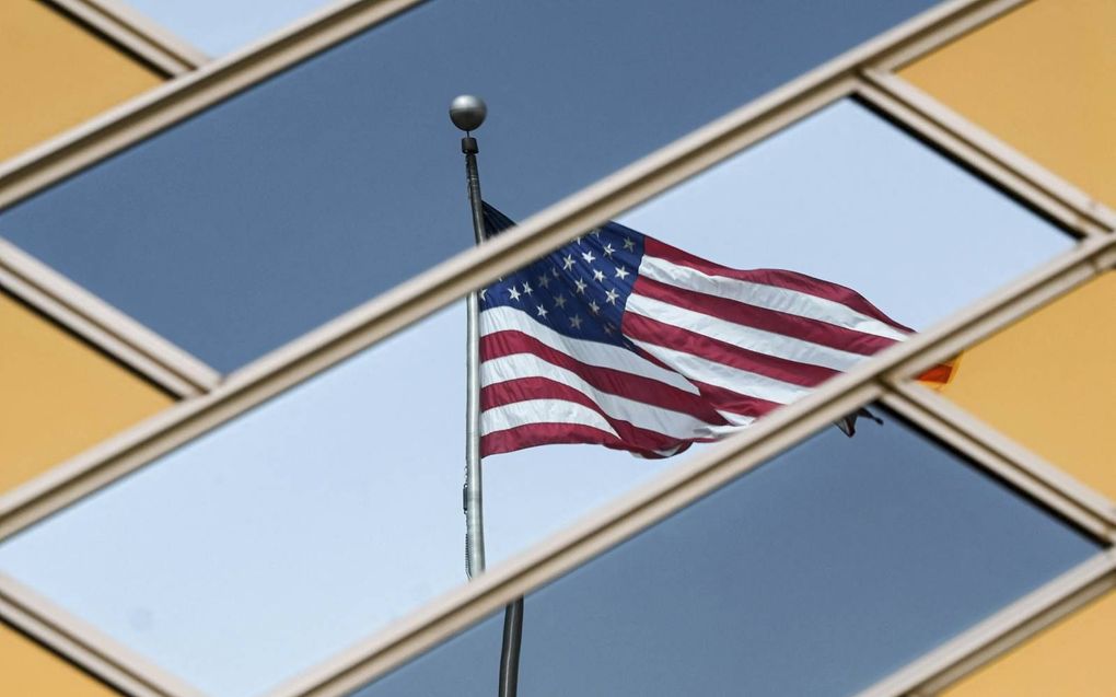 Amerikaanse vlag, gereflecteerd in de ramen van de ambassade van de VS in Kabul, juli 2021. beeld AFP, Sajjad Hussain