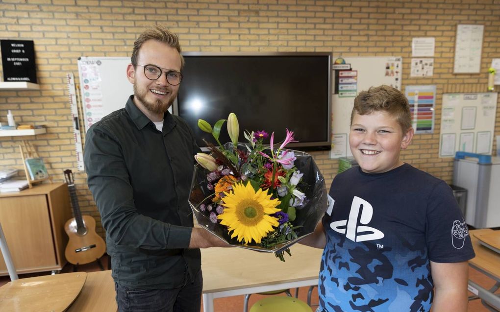 Jos geeft een bloemetje aan meester Zijl omdat die er altijd voor hem is. beeld Martin Droog