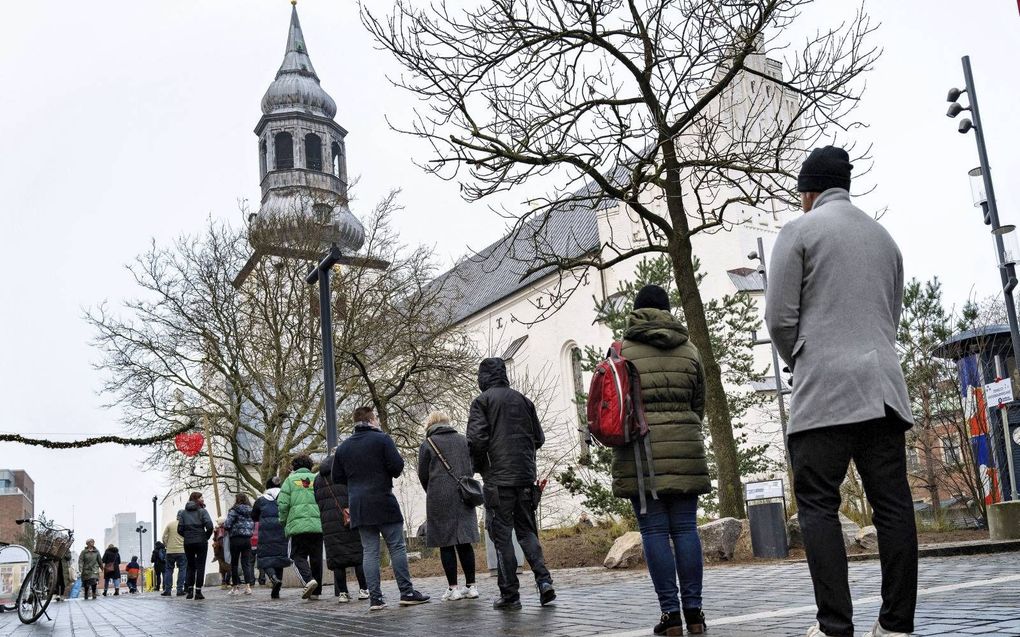 In de rij voor de teststraat: tot voor kort een bekend beeld in Denemarken. beeld AFP
