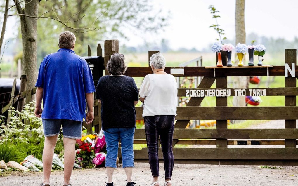 Mensen leggen bloemen bij zorgboerderij Tro Tardi in Alblasserdam. beeld ANP, Jeffrey Groeneweg