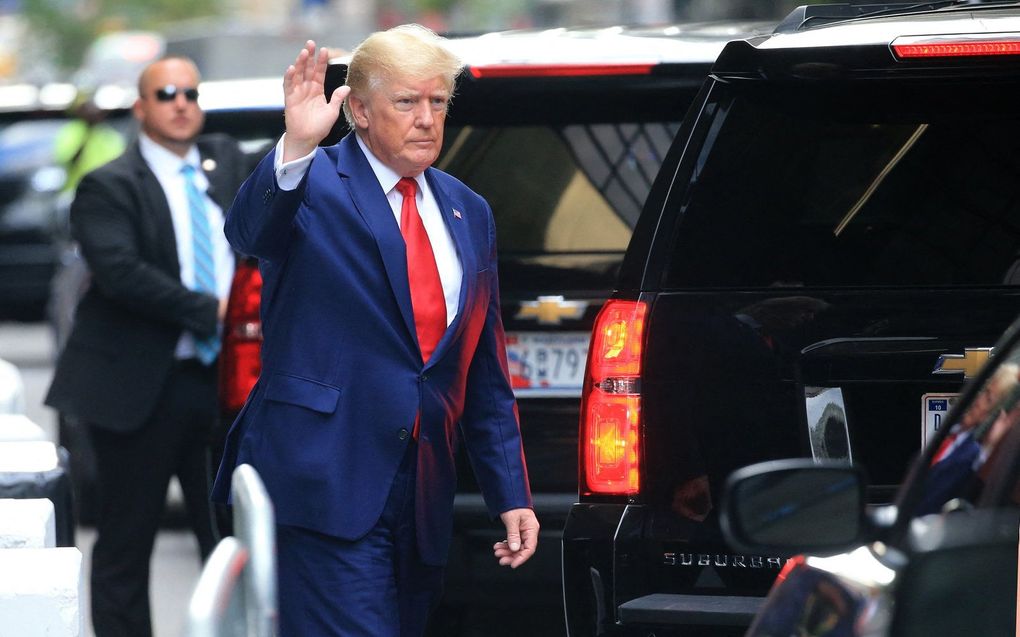 De voormalige Amerikaanse president Donald Trump zwaait terwijl hij naar een voertuig loopt buiten de Trump Tower in New York City. beeld AFP, Stringer