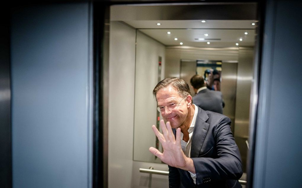 Premier Rutte groet de wachtende verslaggevers terwijl hij dinsdagochtend de lift neemt naar de VVD-vleugel in het Tweede Kamergebouw. beeld ANP, Bart Maat