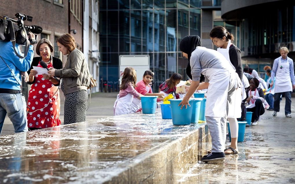 Leerlingen maken in 2011 de Grondwetbank in Den Haag schoon. beeld ANP, DAVID VAN DAM