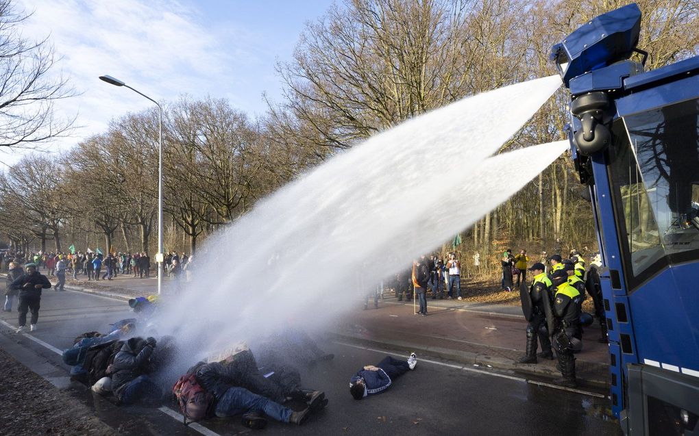 De politie zet het waterkanon in tegen actievoerders van Extinction Rebellion. beeld ANP, SEM VAN DER WAL