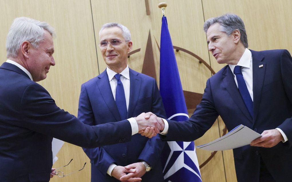 De Finse minister van Buitenlandse Zaken Pekka Haavisto (L) schudt de hand van de Amerikaanse minister van Buitenlandse Zaken Antony Blinken terwijl NAVO-secretaris-generaal Jens Stoltenberg glimlachend toekijkt; tijdens een toetredingsceremonie bij de bijeenkomst van de NAVO-ministers van Buitenlandse Zaken in het hoofdkwartier van de Alliantie in Brussel, België. beeld EPA, Johanna Geron