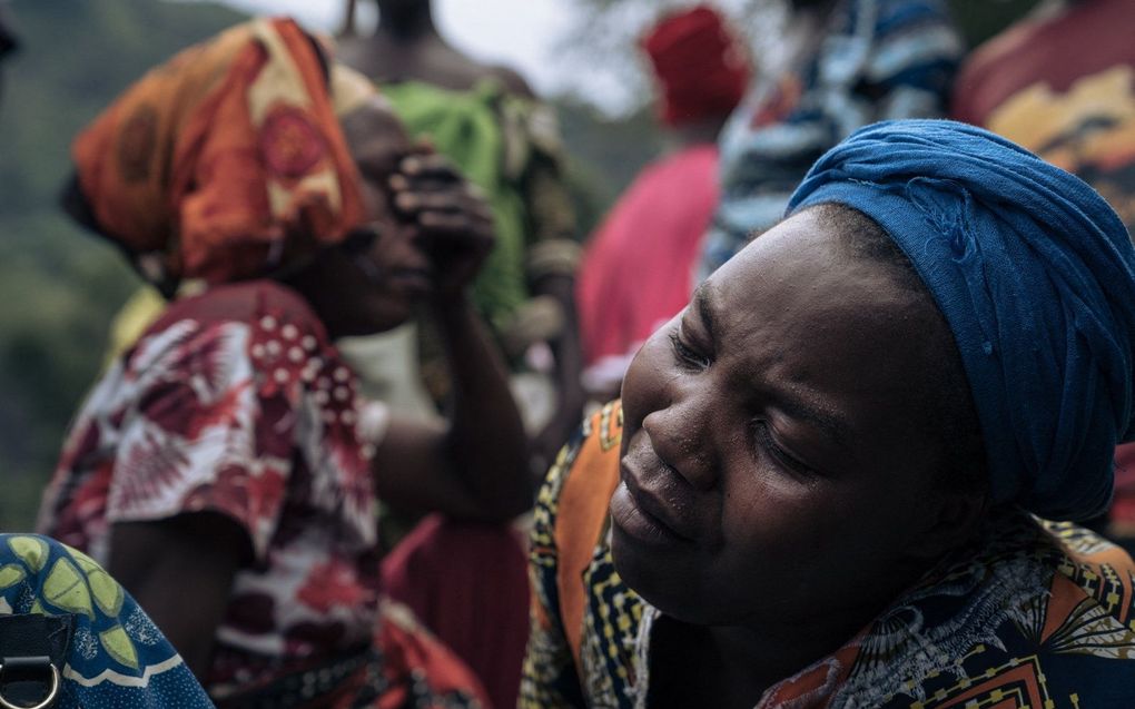 Rouw nadat familieleden omkwamen. beeld AFP,  Glody MURHABAZI