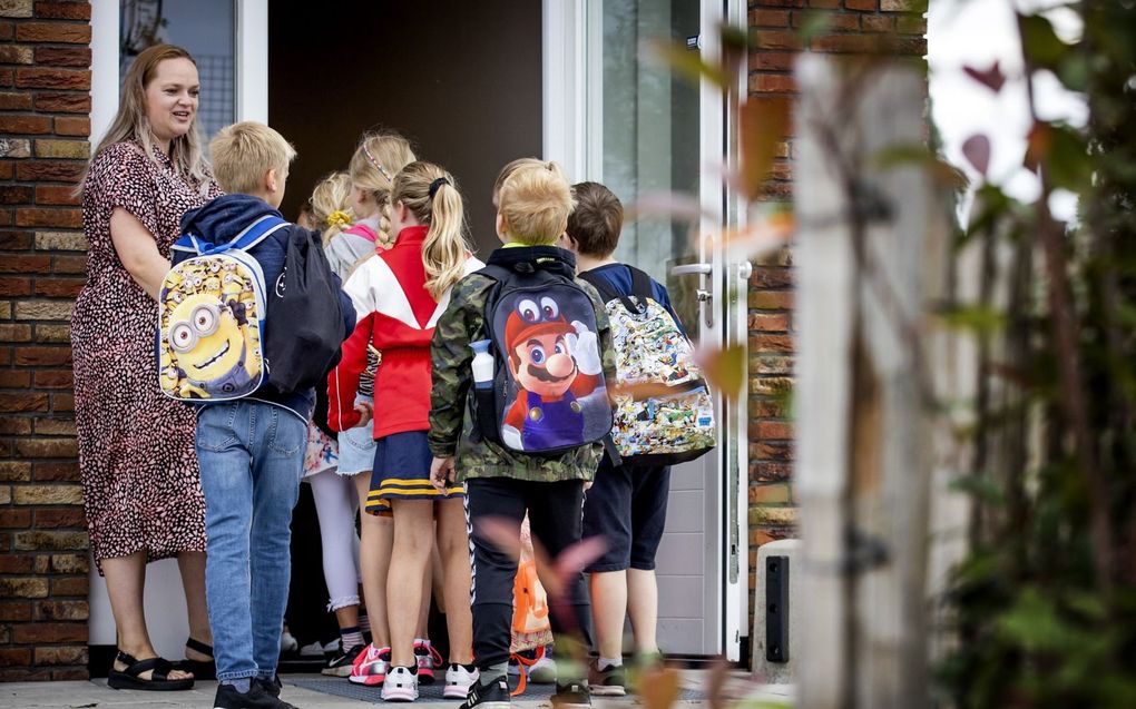 Leerlingen komen aan op een basisschool op de eerste dag van het nieuwe schooljaar. beeld ANP, Koen van Weel