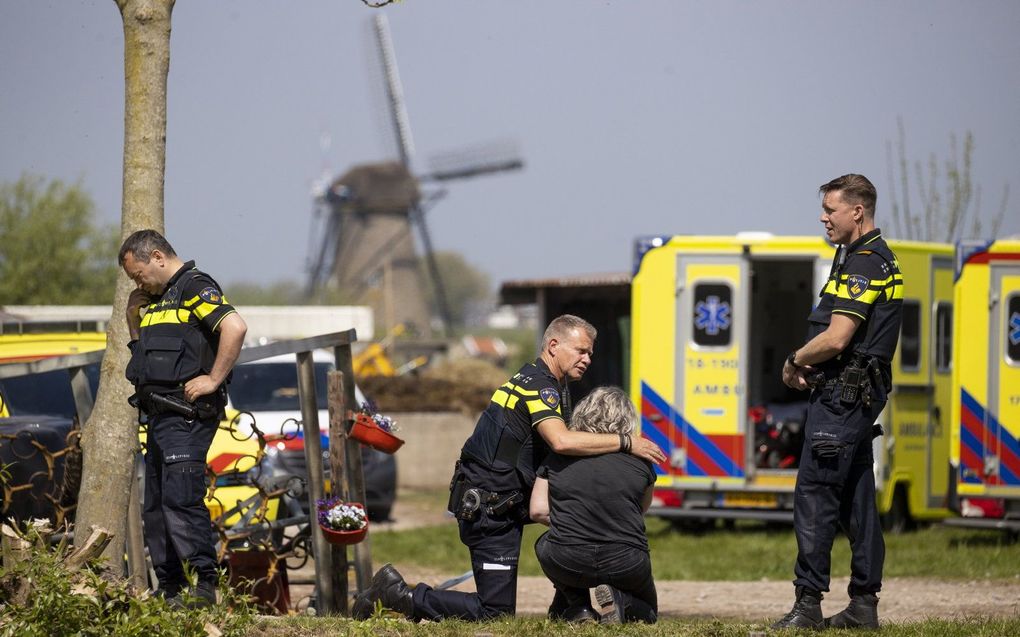 Kort na de schietpartij op zorgboerderij Tro Tardi in Alblasserdam troost een agent een vrouw. beeld ANP, Sem van der Wal