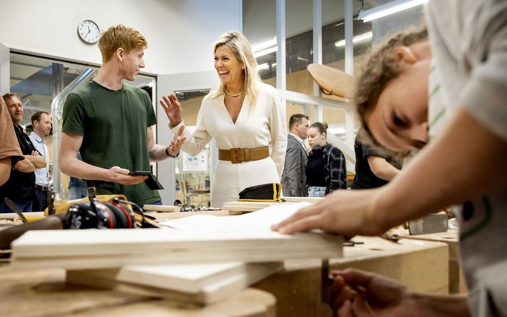 Koningin Máxima donderdag tijdens een rondleiding in het Hout- en Meubileringscollege (HMC) in Rotterdam. De koningin kreeg verschillende werkstukken van studenten te zien, zoals een wieg, een meubel van spijkerbroeken en een zelfontworpen tiny house. beeld ANP, Koen van Weel