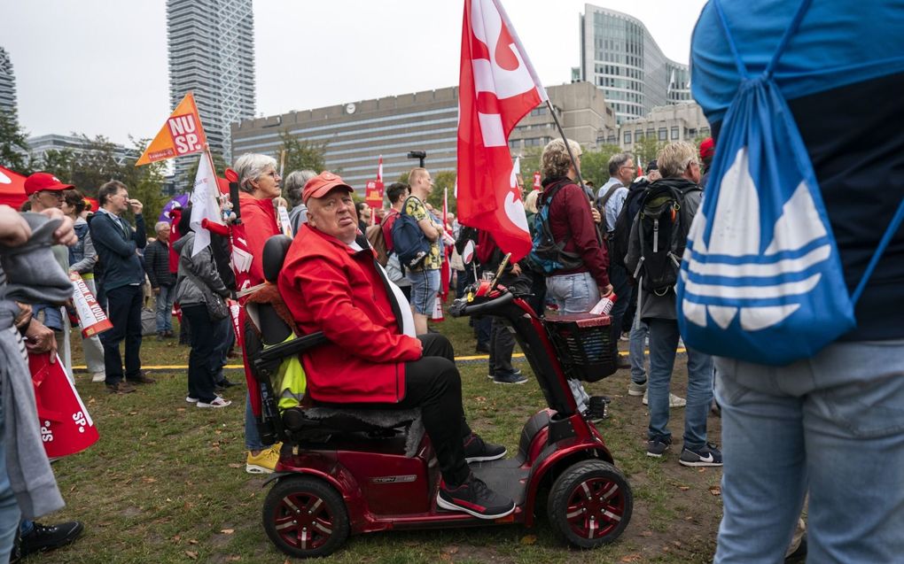 Een oudere protesteert samen met de SP tegen de gestegen kosten van levensonderhoud en eist actie van het kabinet. beeld ANP, Jeroen Jumelet