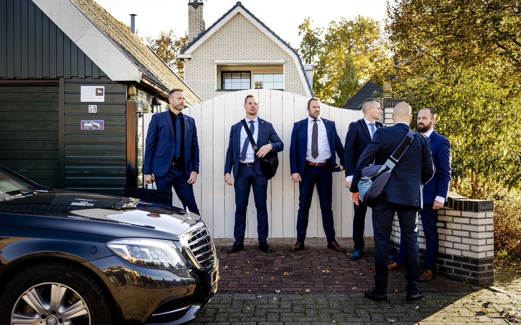 Beveiligers van PVV-leider Geert Wilders bij een woning waar hij met inwoners en plaatselijke ondernemers van Ter Apel in gesprek is. beeld ANP, Robin van Lonkhuijsen