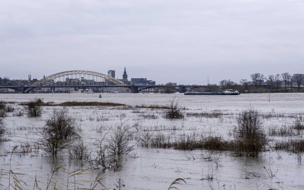 De weg naar de Vlietberg in Ooij bij de Waal is bijna ondergelopen. In de verte ligt Nijmegen. beeld ANP, Manon Bruininga