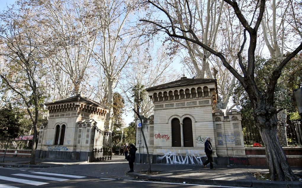 Mensen lopen langs de ingang van Villa Bellini, de grootste openbare tuin in het Siciliaanse Catania. In de openbare toiletten van het gebouw werd recent een meisje (13) verkracht door Egyptische jongeren. beeld EPA, Orietta Scardino.