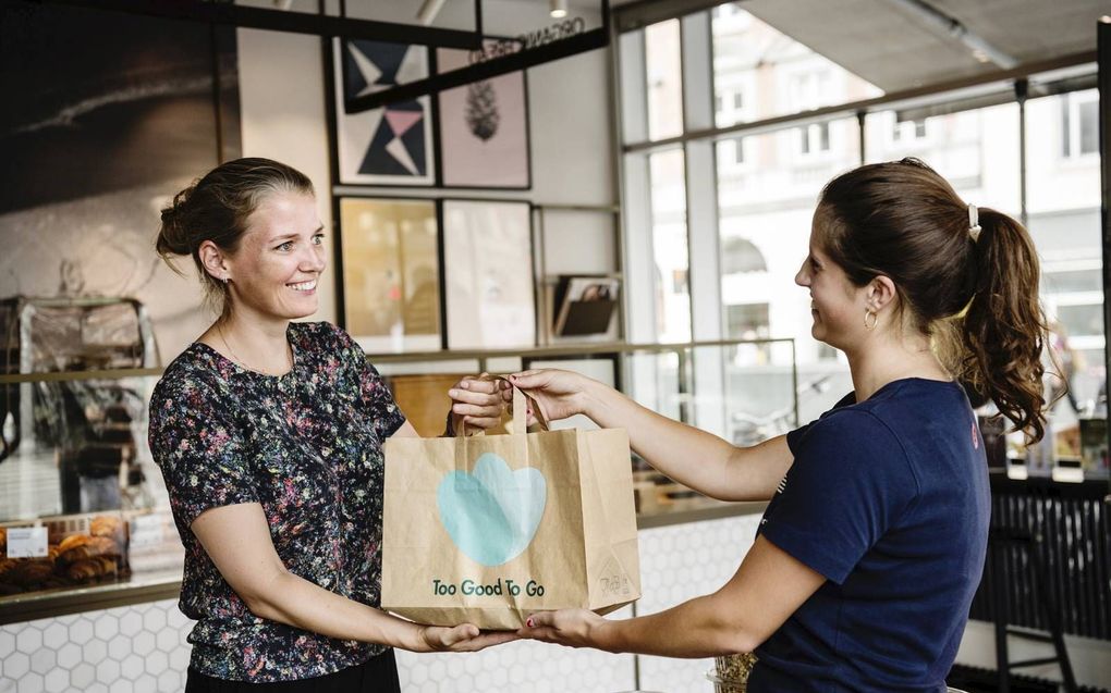 De Deense Mette Lykke, de CEO van Too Good To Go, neemt een zogenoemde magic bag in ontvangst. beeld Too Good To Go