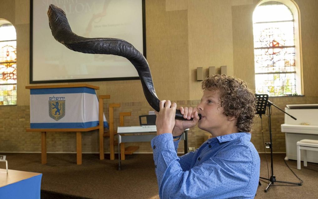 Een zoon van voorganger Willem Dane blaast de sjofar. Beeld Dirk-Jan Gjeltema